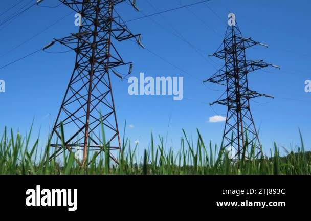 Towers of high-voltage power lines against the blue sky. Metal towers ...