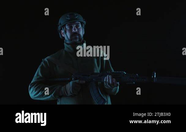 Soldier of Ukraine with a Kalashnikov assault rifle on a black ...
