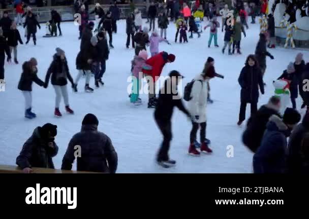Ukraine, Kyiv - January 7, 2022: Ice skating rink in winter. People are ...