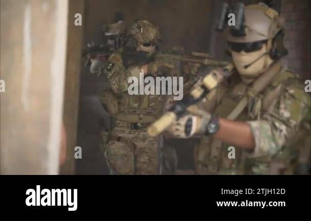 Smart teamwork of soldiers walking forward and attacking enemy during ...