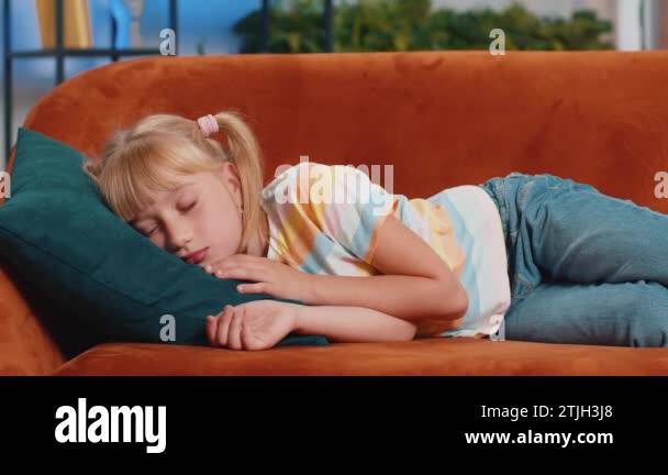 tired-preteen-school-girl-lying-down-in-bed-taking-a-rest-at-home-on