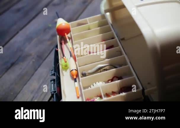 Box for fishing hooks.Man showing fishing tools outdoors.Set of multicolour  lures and fish-hooks for the fishing hobby. High quality FullHD footage  Stock Video Footage - Alamy