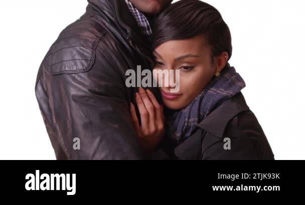 An African American couple hug on a white background. A black man and ...