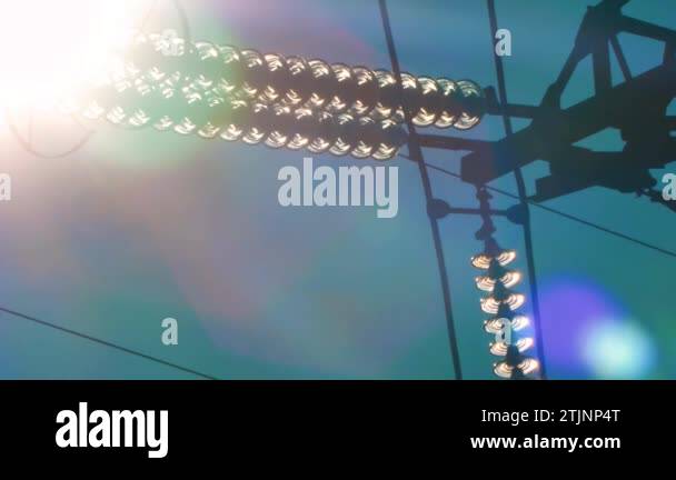 Power lines with sun rays on blue sky. High voltage substation ...
