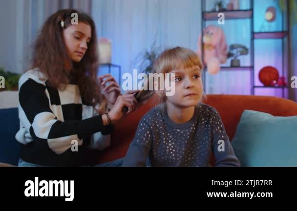 Teenage and little sisters child kids using combs brushing make ...