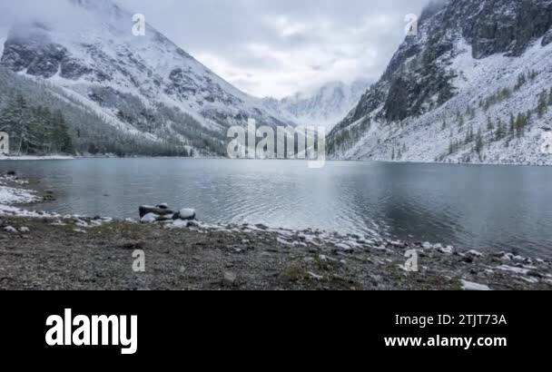 4K UHD snow mountain lake timelapse at the autumn time. Wild nature and