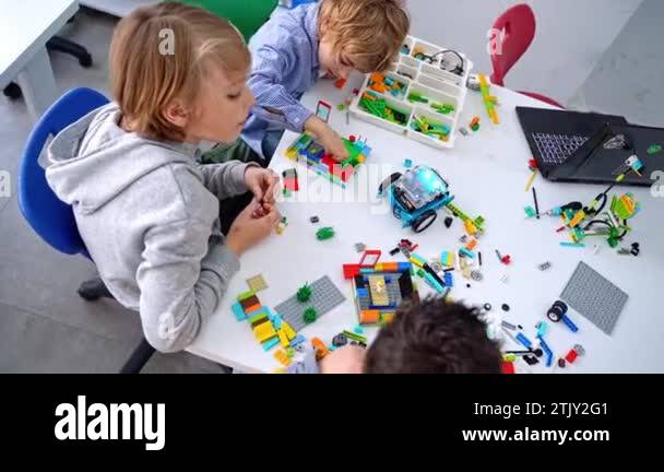 Robotics programming class. Children construct and code Robot. STEM ...
