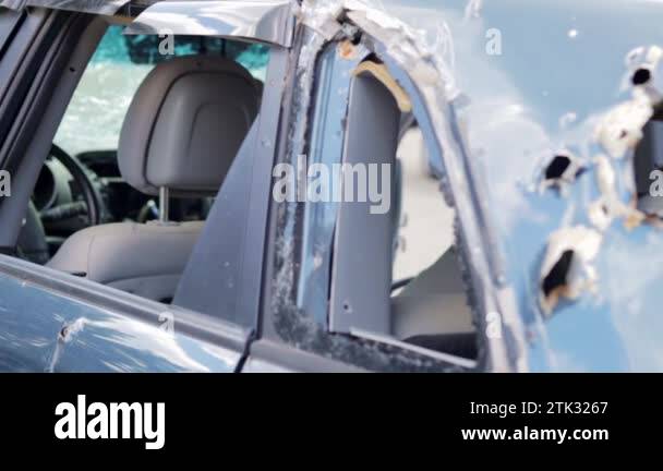 Car riddled with bullets. War of Russia against Ukraine. A car of ...