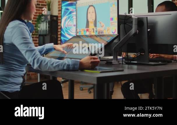 Creative company employee working with touchscreen display to edit ...