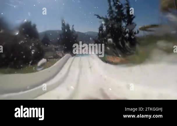 Descent from the slide in the water park, rapid descent, front view ...