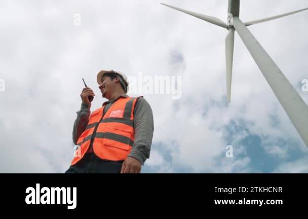 Engineer working on a wind turbine with the sky background. Progressive ...