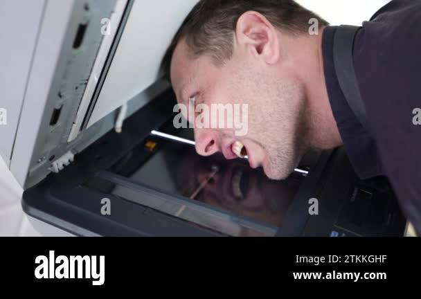 The process of scanning a man's face. Scanner in operation scans a ...