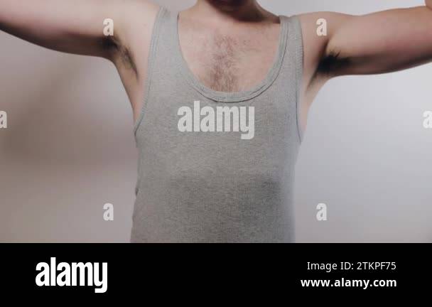 Slow motion shoot of strong man rising his arms, showing biceps and ...