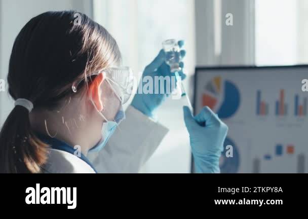 The doctor fills the syringe with medicine. A nurse in a hospital ...