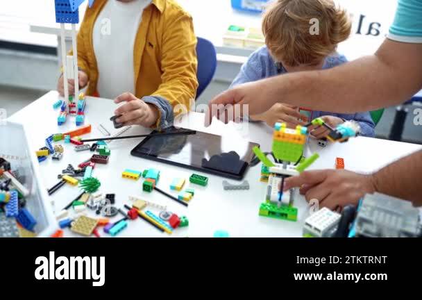 Robotics programming class. Children construct and code Robot. STEM ...