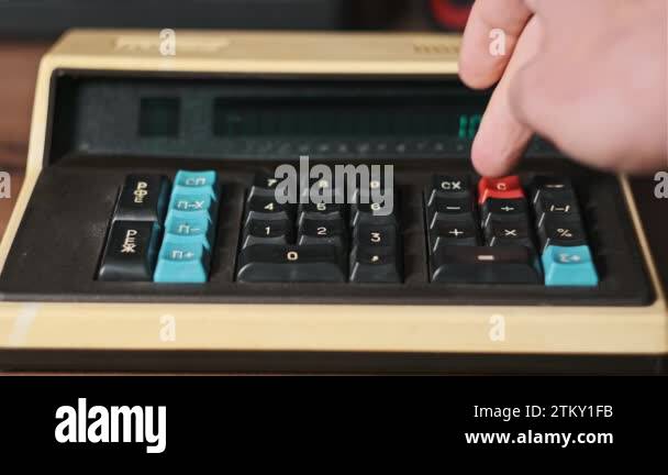 Counting on a vintage calculator. Male hand press buttons on an old ...