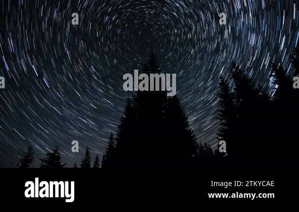 Time lapse of Star trails in the night sky. Stars move around a polar ...