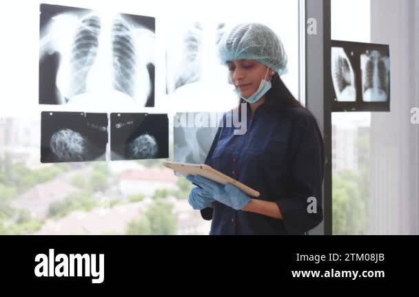 Indian female healthcare practitioner in protective uniform holding ...