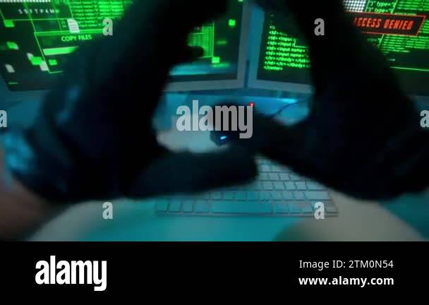 Hacker stretching hands in black gloves and typing on a computer ...