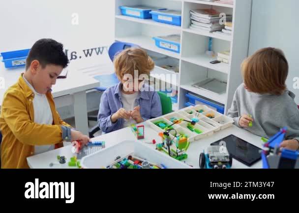 Robotics programming class. Children construct and code Robot. STEM ...