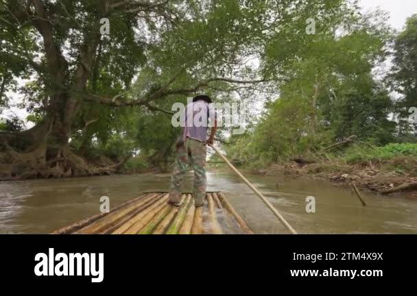 Pushing Raft Chiang Mai, Thailand - 5 December 2022 - Back of a local man on bamboo ...