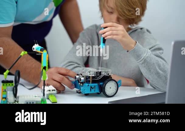 Robotics programming class. Children construct and code Robot. STEM ...