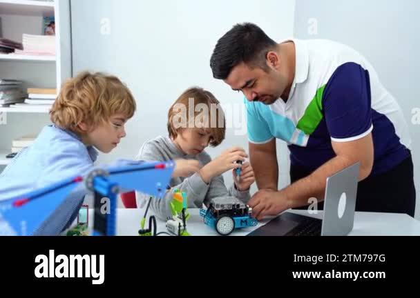 Robotics programming class. Children construct and code Robot. STEM ...