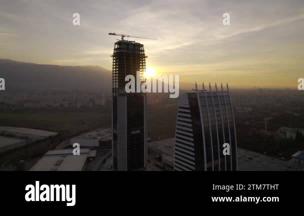 high-rise office building bathed in the warm hues of a gorgeous sunset ...