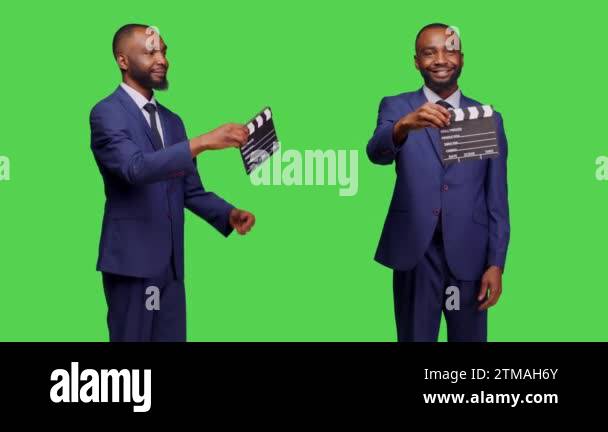 Businessman filmmaker holding filming slate on camera, using ...