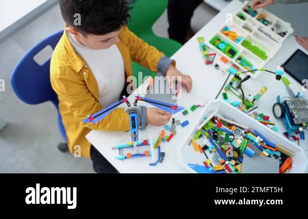 Robotics programming class. Children construct and code Robot. STEM ...