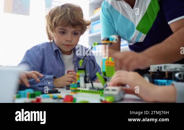 Robotics programming class. Children construct and code Robot. STEM ...