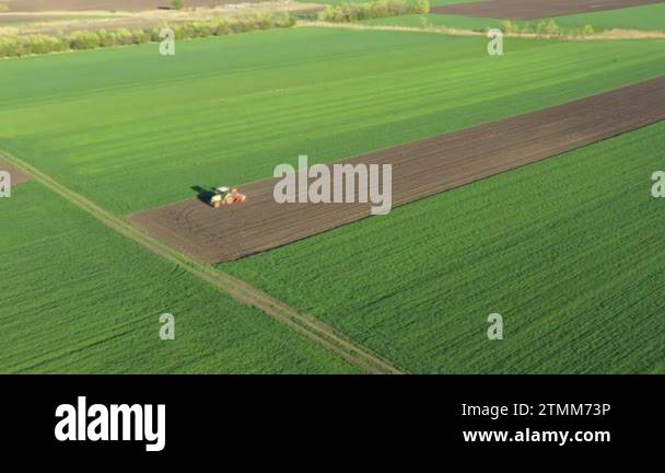 Above rotation view, orbit dolly move, of tractor as pulling mechanical ...