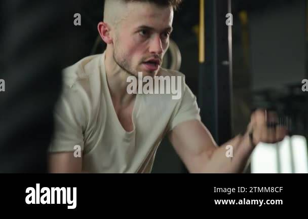 Strong Caucasian man pull battle ropes burn energy training biceps