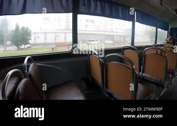 View from window of moving bus. Different buildings of city in window ...