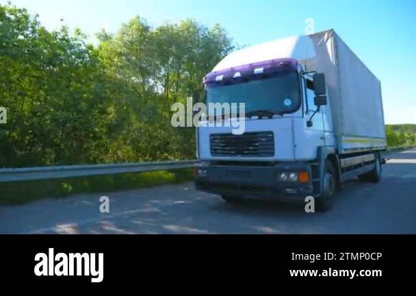 Big truck with cargo trailer driving on highway and transporting goods ...