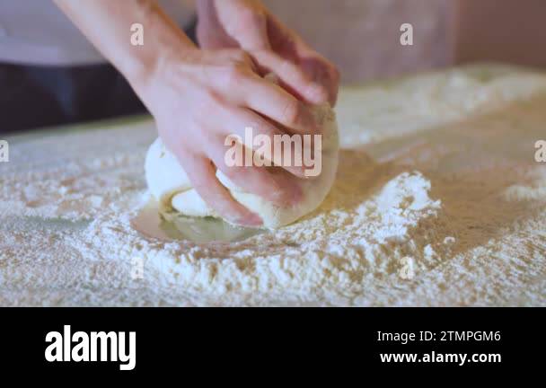 Close Up Making dough by female hands at bakery. shot of hands of woman ...