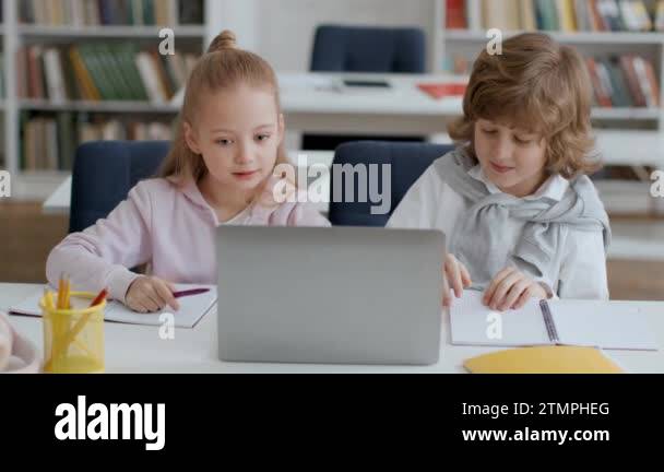 Collective study time for vibrant preteen students. Cute boy and girl ...