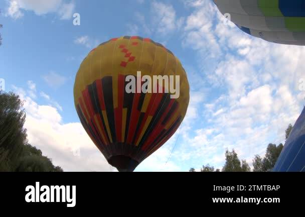 Large Balloon filling up hot air and rising, flying up into air ...
