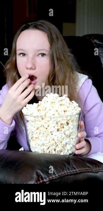 Watching a movie with eyes wide open eating popcorn open wide-eyed ...