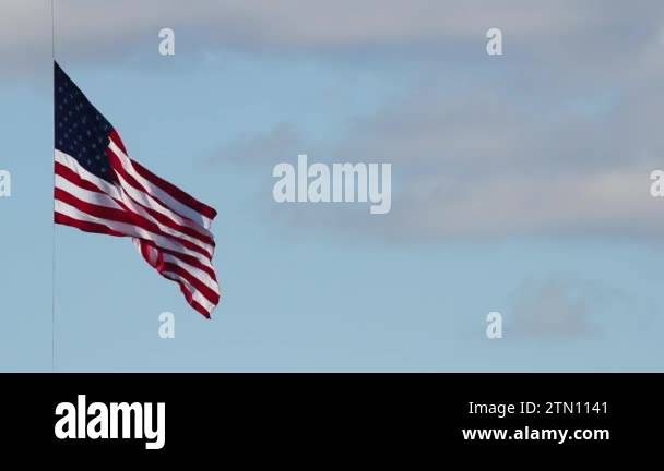 American Flag Flying High on July 4th Independence Day against Blue Sky ...