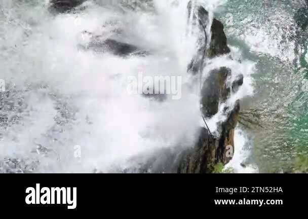 Unveil the aerial gem of the famous waterfall surrounded by a green ...