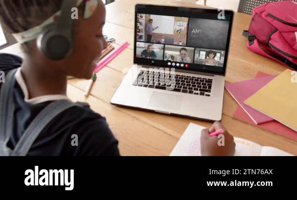 African american female student using laptop for online lesson with ...