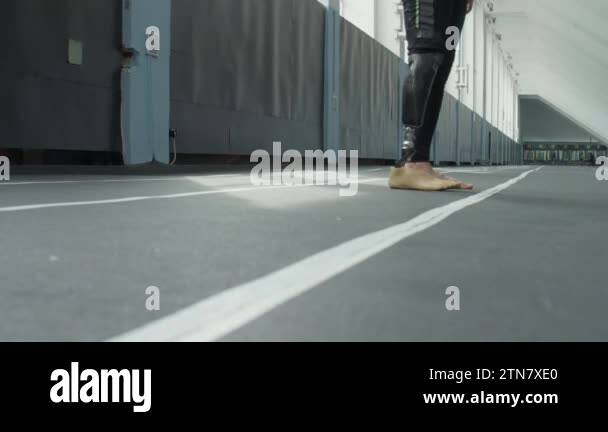 Ground level shot of legs of professional male athlete with prosthetic ...