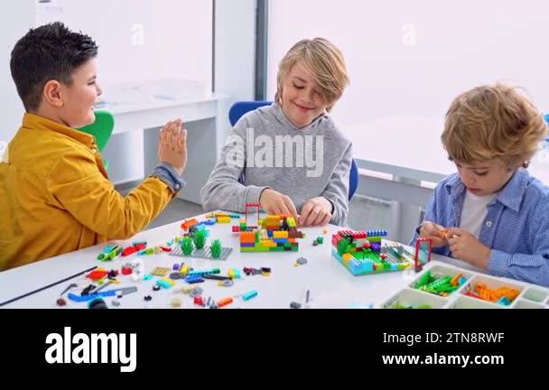 Robotics programming class. Children construct and code Robot. STEM ...