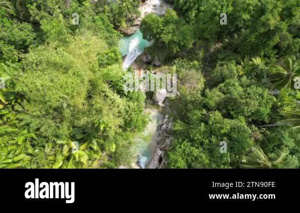 Drone footage of a beautiful waterfall in the Philippines with blue ...