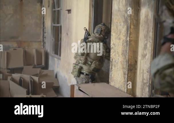 Smart teamwork of soldiers walking forward and attacking enemy during ...