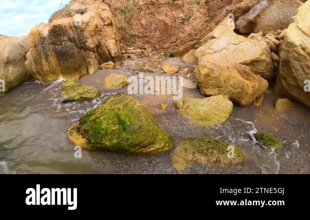 Waterside Rocks Clay sand on beach Stock Videos & Footage - HD and 4K Video Clips - Alamy