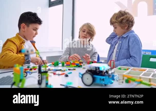 Robotics programming class. Children construct and code Robot. STEM ...
