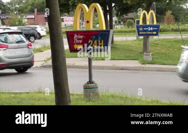 mcdonalds drive thru signs on posts at entrance with one in front of ...