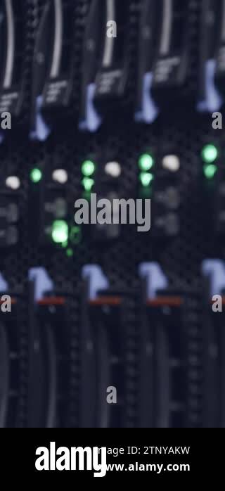Vertical video of a large computer server room in a data center with ...